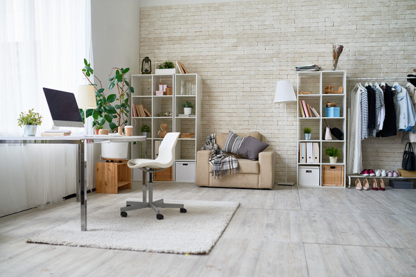 Bright and cozy home office with brick wall