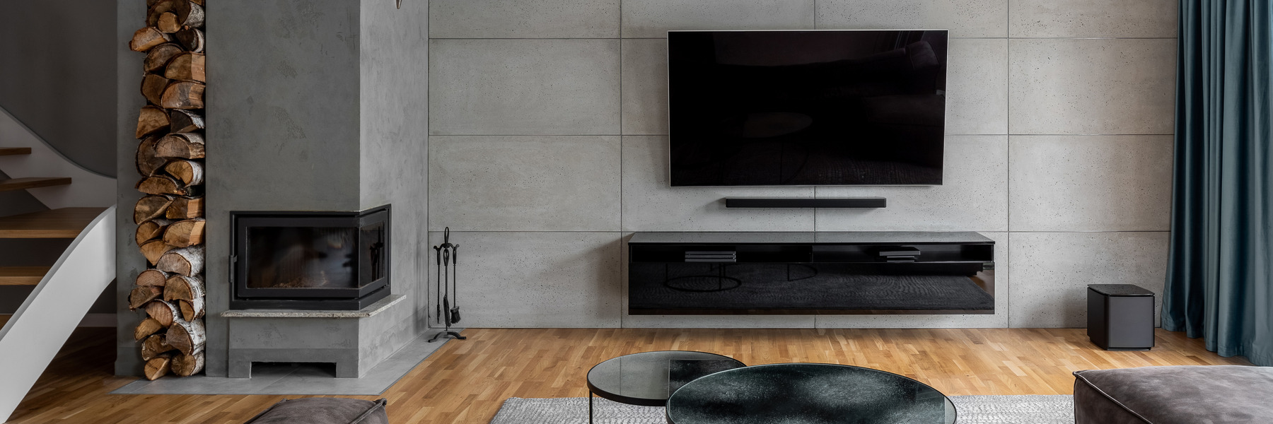 Smooth grey panelling behind the TV providing a sleek, modern backdrop.