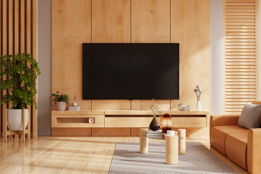 Minimalist light wood panelling behind the TV with neutral decor.