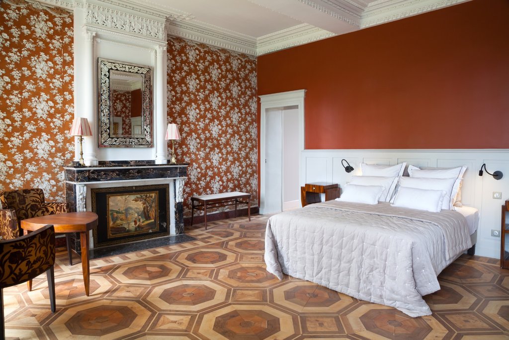 Luxury bedroom with floral wallpaper and panelled walls