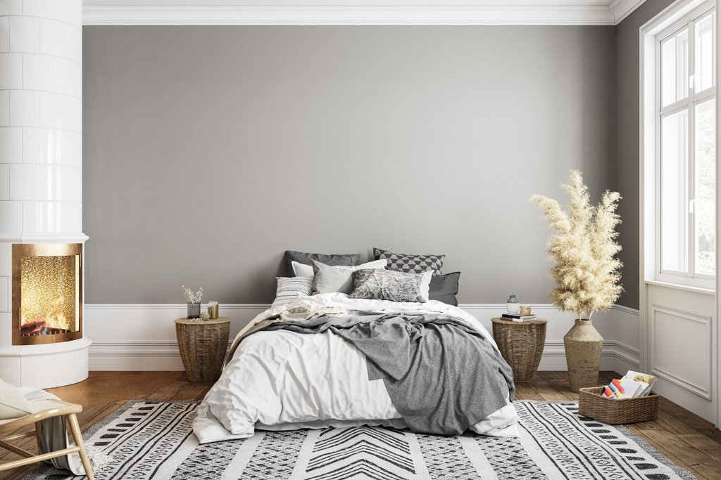 Minimalistic bedroom with grey walls and fireplace, complemented by wood panelling