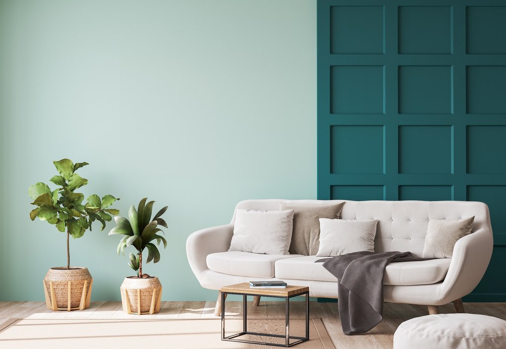 Mint green wall with teal square panelling in a modern living room