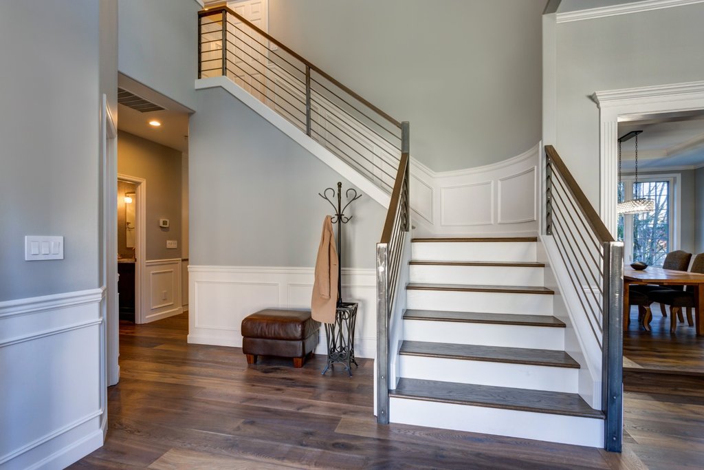 Modern hallway with white wainscoting panelling and staircase