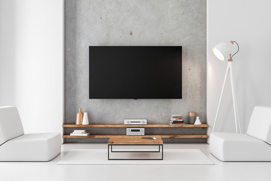 Concrete panelling adding an industrial edge behind the TV.