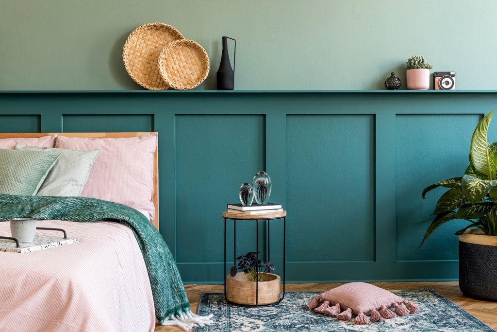 Teal board and batten panelling in a modern bedroom with soft lighting