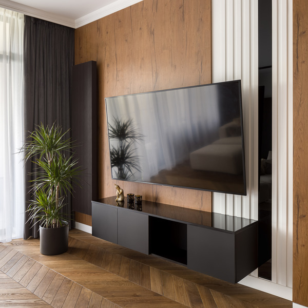 Dark wood panelling behind the TV providing a sophisticated contrast.